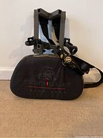 Front view of Gorilla treestand showing padded black seat with Gorilla logo and attached securing straps.