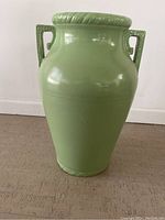 Front view of large green ceramic floor vase showing full height, handles, and glossy finish.
