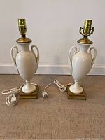 Pair of Lenox ceramic lamps with brass fixtures and square brass bases, with attached cords and plugs.