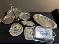 Overall set showing all silver plated items together on a dark surface.