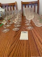 Side view of the glasses arranged on a table, showing cut glass details on stems and overall set layout.