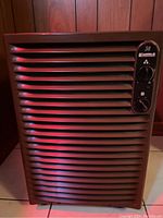 Front view showing horizontal grille, control panel with model number 38 and two knobs.