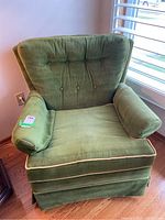 Front view of the vintage green velvet arm chair showing tufted backrest and mustard yellow piping around cushions and arms.