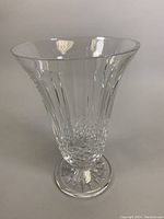 Front view of a clear Waterford crystal vase showing vertical cut panels and detailed lower cut pattern with starburst base.