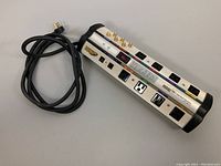Top angle view of Monster Power HTS 1000 MKII power strip showing power cord, AC outlets, coax connectors, and transient voltage meter.