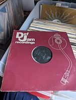 A large bin containing dozens of 12-inch vinyl records with Def Jam Recordings branded sleeve visible on top.