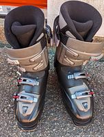 Front view of the pair of black and gray Tecnica Entryx men's ski boots with four buckles each.
