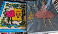 Two vintage doll cases, one Barbie and one Midge, showing front illustrations and condition