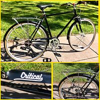 Full view of the black Critical Beaumont city bike featuring 54cm frame, rear rack, fenders, and tan sidewall tires.