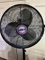 Close-up of the fan's front grille showing Lasko branding and details of the blade design.