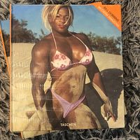 Front cover of 'Modern Amazons' book showing a bodybuilder woman on the beach in bikini, sealed in plastic wrap.