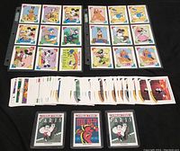 Two rows of classic Disney character trading cards laid out in plastic page protectors with vibrant illustrations of Mickey, Minnie, Donald, Goofy, Pluto and more.