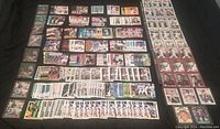 Full spread of hundreds of baseball cards laid out showing multiple players and teams, including duplicates and diverse card styles.
