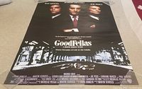 Rolled Goodfellas poster laid out on a surface showing full view of poster, clear title and credits.