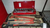 Overall view of hand tools including socket set in red box, bolt cutters, pipe wrench and level