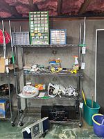 Full view of four-tier NSF rolling wire shelf unit with various items placed on shelves but not included in sale.