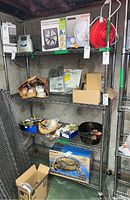 Full view of the 4-tier metal wire shelving unit with items placed on various shelves.