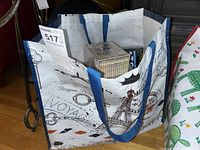Photo of a reusable tote bag containing multiple boxed DVD sets visible inside, providing an overview of the lot contents.