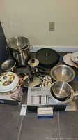 Overview of all cookware items including pots, pans, lids, buffet server, and colander, showing the full set included