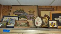 Wide view of nine pieces of wall art including floral and animal subjects, various frame styles and sizes, largest piece measures 21x24 inches
