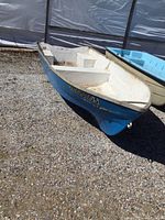 Starboard bow view showing blue exterior hull with registration number ON1001105 and white interior.