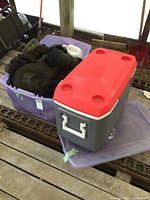 Clear view of the Coleman cooler and totes with camping items.