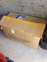 Large cardboard box labeled Seachoice Products partially opened revealing packed items inside.