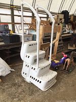 Overall view of resin pool ladder with handrails and base steps