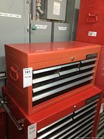 Front angled view showing the nine total drawers (8 small front drawers plus lift lid), Craftsman logo on front right corner, red color.