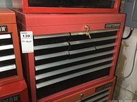 Front view of red Craftsman tool chest top box showing 12 drawers, lock with key, and Craftsman branding