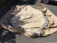 Large square canvas cover laid out flat showing size and gray reinforced edging.