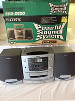 Sony CFD-Z500 sound system with box showing model and features, including detachable speakers and powerful sound system branding.