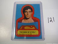 Front image of the 1978 Superman sticker showing the head and chest of Superman with blue background, red border around the figure, and yellow text box identifying The Man of Steel and copyright.