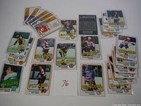 Overview of the 25 assorted 1981 Topps hockey cards spread out, showing various players and teams.