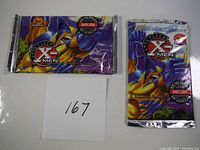 Two unopened 1996 Fleer X-Men trading card packs with character art and promotional text.