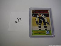 Front of 1975-76 NHL Second Team All-Stars Borje Salming hockey card in protective sleeve with handwritten lot number.