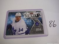 Front of the 2017-18 Upper Deck Auston Matthews Next Up Compendium card showing player in Toronto Maple Leafs uniform, card number 34.