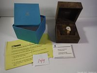 Gold-tone City of Toronto 25 Year Employee Service watch in brown presentation box with outer blue box and yellow employee service certificate paperwork.