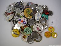 Photo showing a spread of many vintage pinback buttons with visible slogans and metal backs.