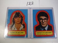 Front view of the two trading cards: Lois Lane and Clark Kent from 1978 in protective sleeves.