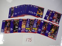 Set of 52 basketball cards laid out, showing player images and backs, with a card number '175' visible.