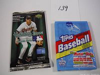 Front view of the 2007 Upper Deck Holiday Inn pack and the 1992 Topps MLB pack showing the player and branding clearly.