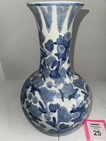 Front view of blue and white porcelain vase showing lotus flower and leaf design with a flared neck