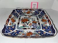 Image showing top view and detailed pattern of the square Imari porcelain platter with floral and bird motifs.
