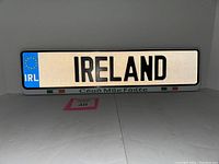 Front view of Ireland license plate showcasing reflective surface, EU blue strip with IRL code, 'IRELAND' text and Céad Míle Fáilte inscription with Irish flags at bottom