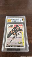 Front view of graded Mario Lemieux hockey card in hard plastic case showing the card and HGA grading label graded 8.5 overall, with 8.5 subgrades for corners, edges, surface, centering.