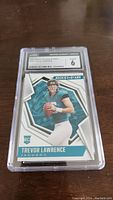 Front view of 2021 Panini Rookies & Stars Trevor Lawrence rookie card graded CGC 6.