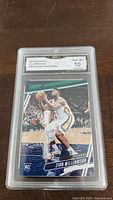 Front of card showing Zion Williamson in game action with green foil accents and Rookie Card logo, graded Gem MT 10 by GMA.