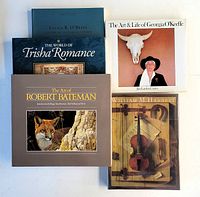 Five large format art books arranged on a white surface showing cover imagery and titles from Robert Bateman, Georgia O'Keeffe, William M. Harnett, Trisha Romance, Lucius R. O'Brien