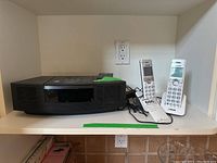 Front view of Bose Wave Radio/CD unit with two VTech cordless handsets on right